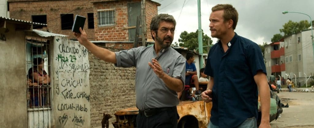 Fathers Julián and Nicolás patrol the shanty