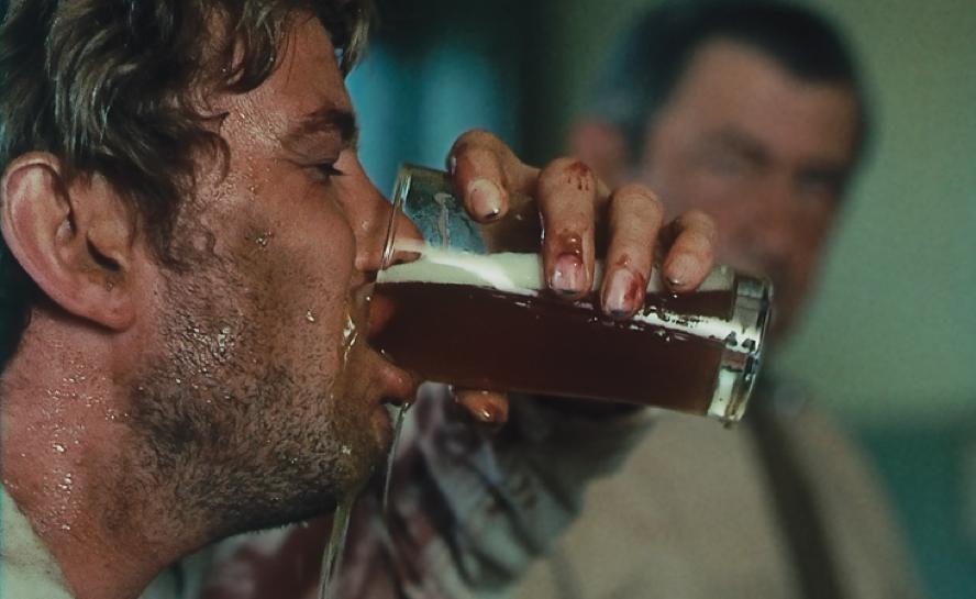 Gary Bond sinks a beer in Wake in Fright