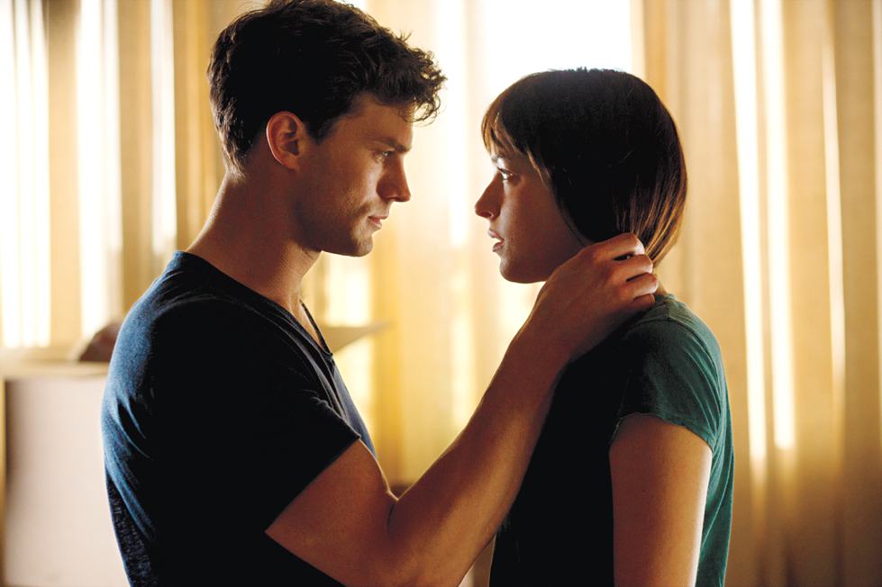Christian Grey shares a tender moment with Anastasia Steele in Fifty Shades of Grey