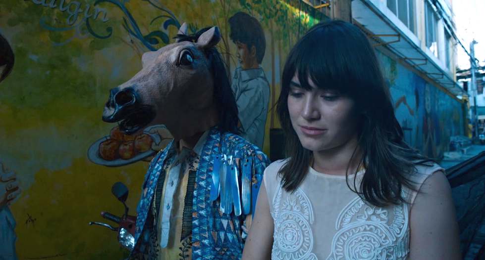 Tadanobo Asano (in horse's head) and Nathalia Acevedo in Ruined Heart