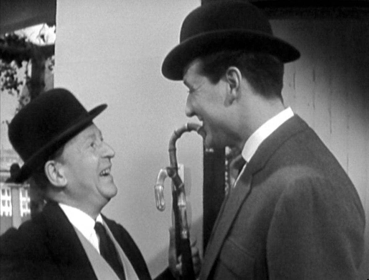 The butler and Steed discuss bowler hats