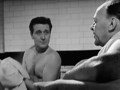 Steed is briefed by One-Ten in a steam room