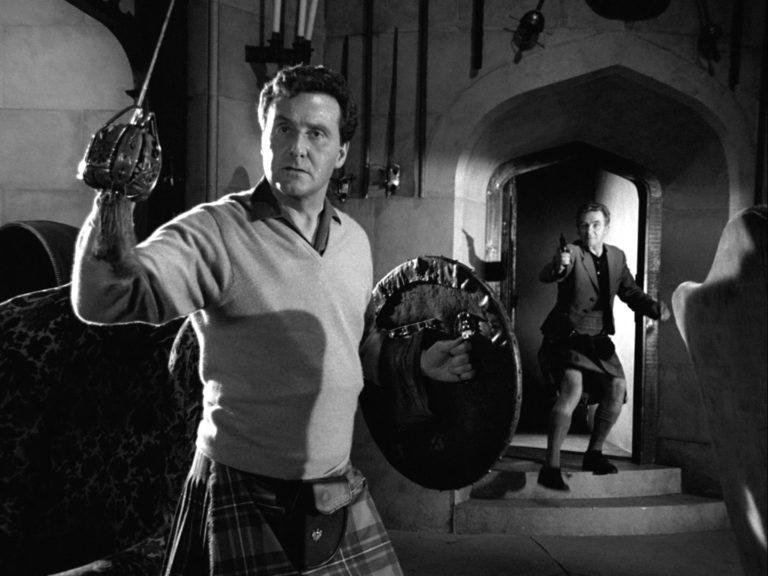 John Steed with a sword. Assailant with a gun
