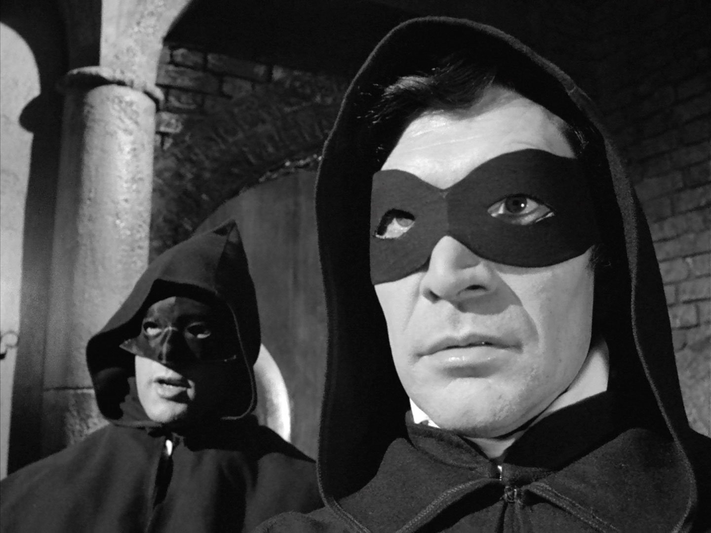 Peter Wyngarde (right) in mask and hood