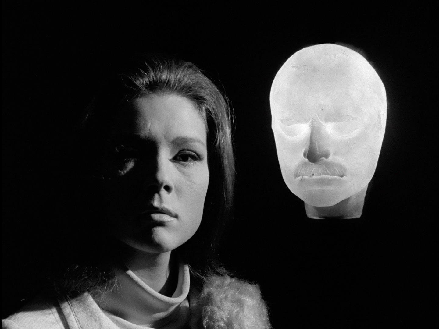 Mrs Peel with an illuinated mask