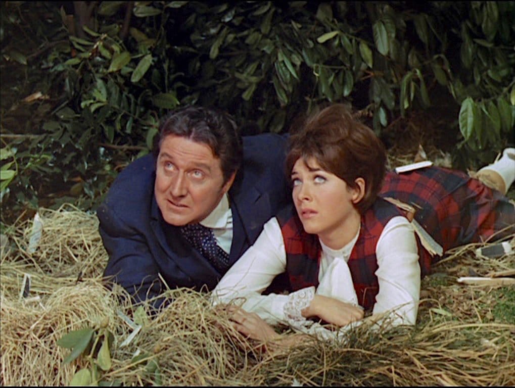 John Steed and Tara King chat while lying in the grass