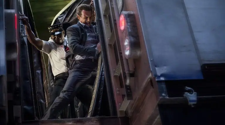 Liam Neeson between two train carriages