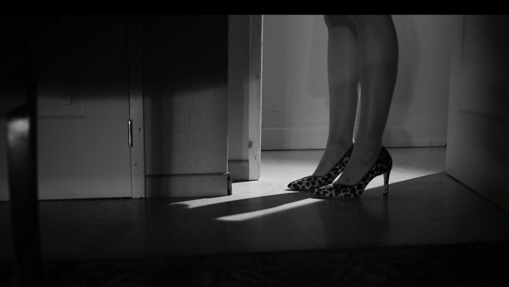 The feet and shoes of the woman with leopard shoes