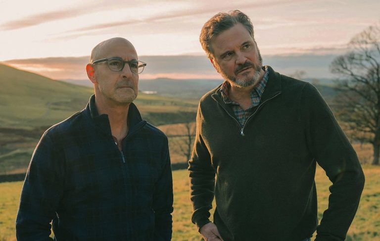 Stanley Tucci and Colin Firth in a field