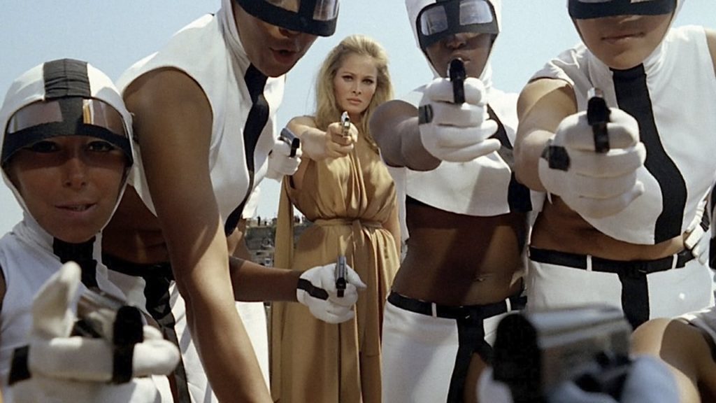 Ursula Andress and crew with guns