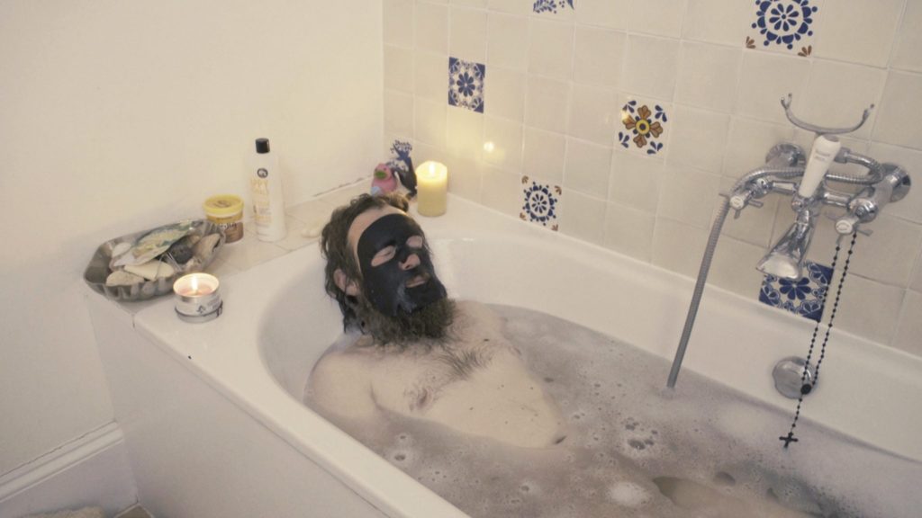 Mikel has a bath, with face mask