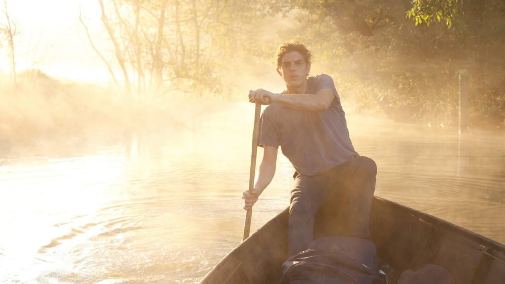 Léo takes a boat up a misty river