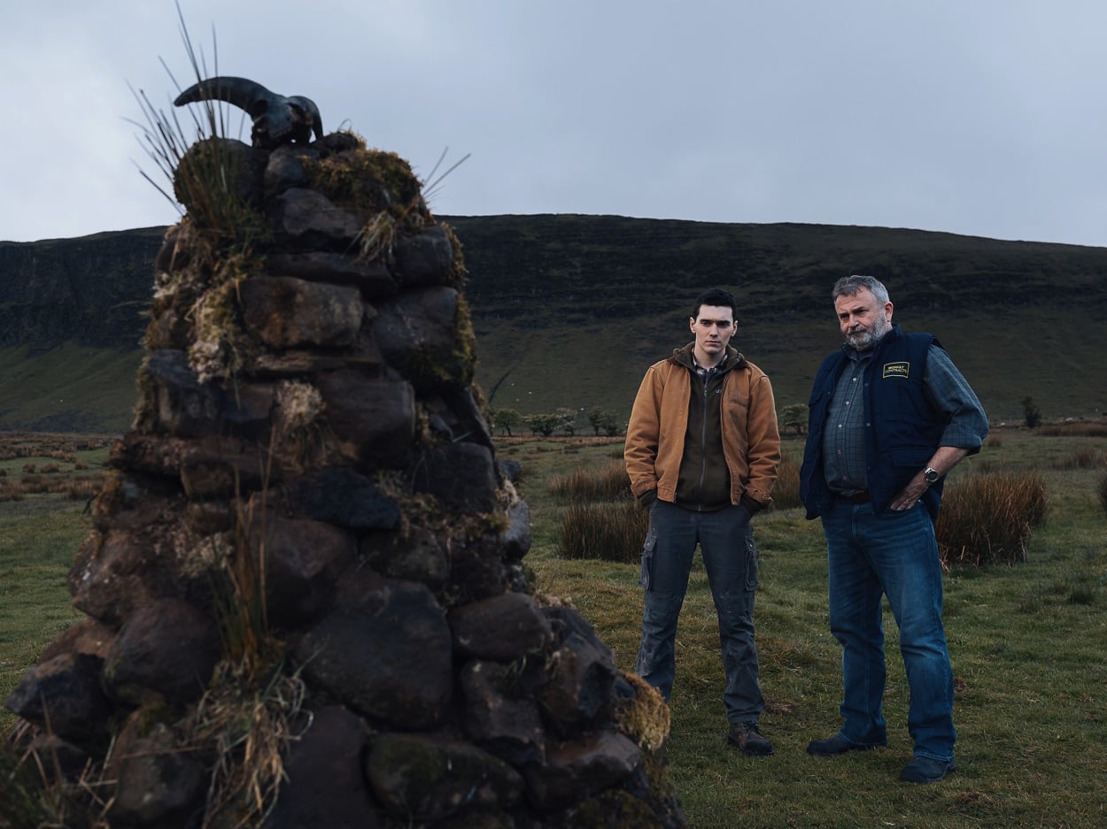 Eugene and dad Francie eye the cairn