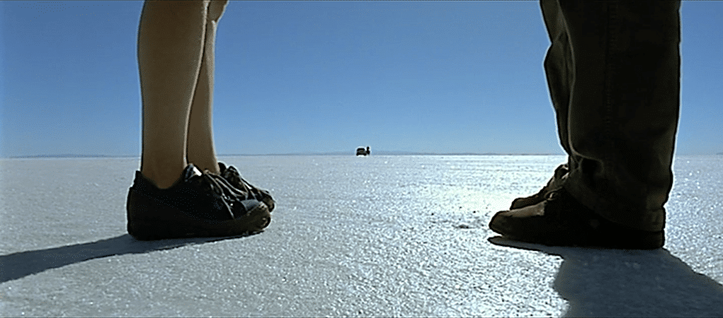 Two pairs of feet on the salt flats