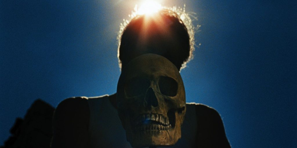 Skull in the foreground, human behind