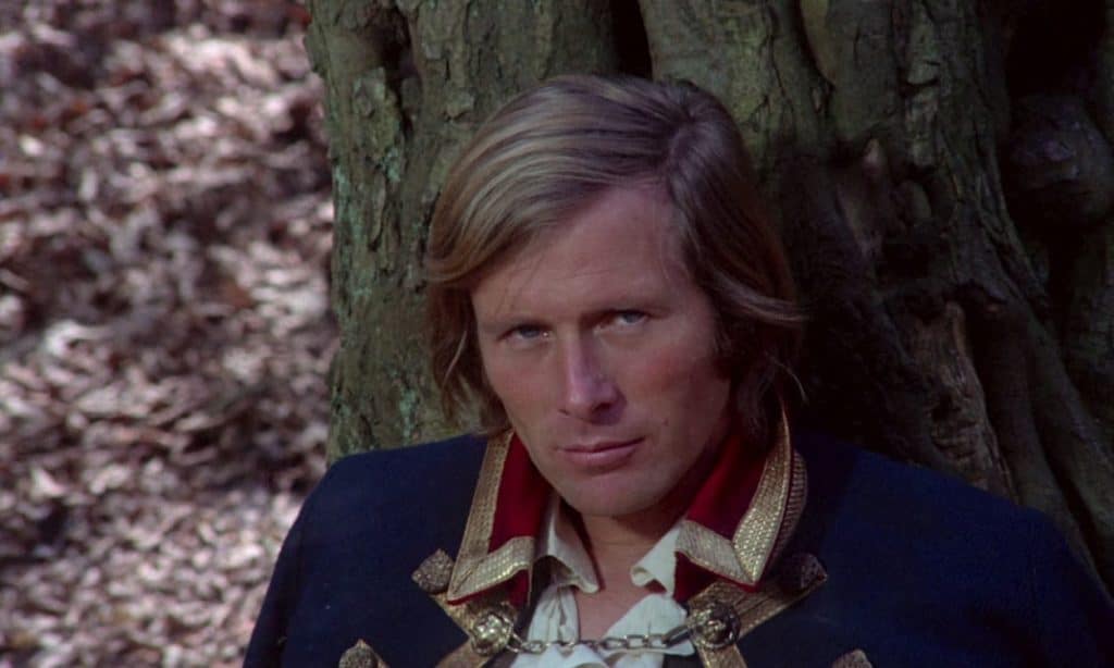 Captain Kronos rests against a tree