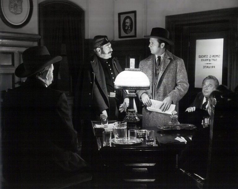 Adolphe Menjou and Dick Powell (centre of pic)