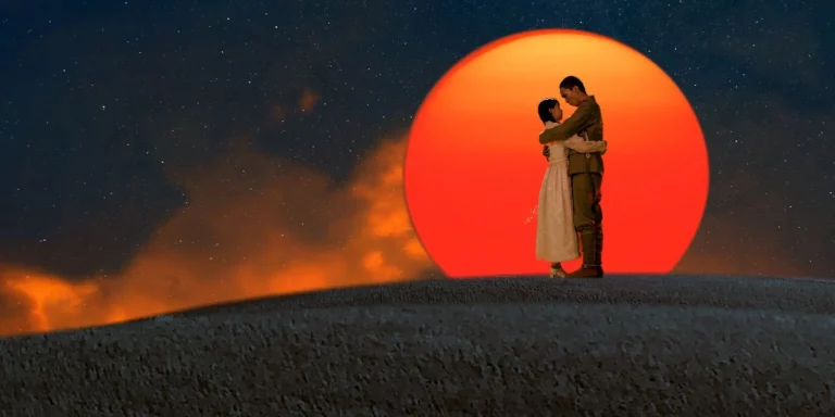 Two lovers silhouetted against a red moon