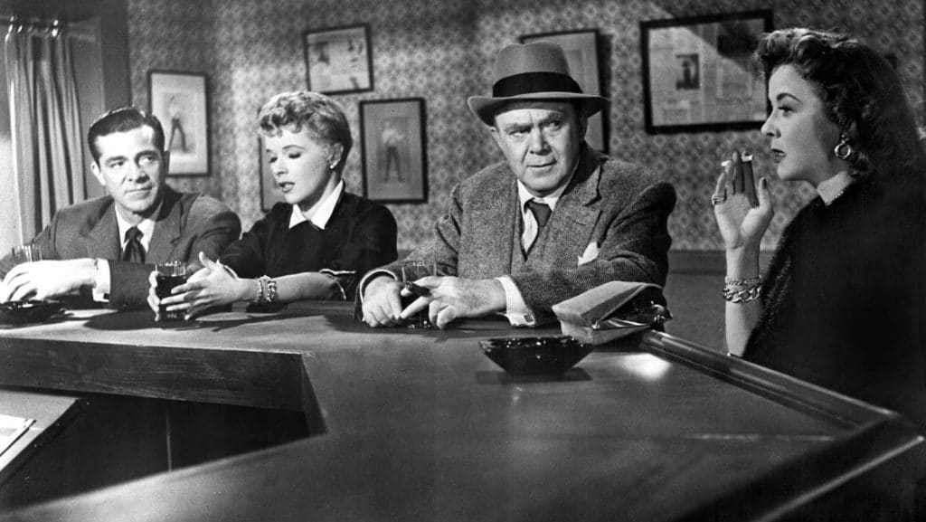 Dana Andrews, Sally Forrest, Thomas Mitchell and Ida Lupino sitting at a bar