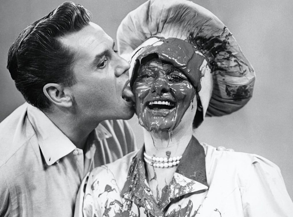 Desi licks chococlate off Lucy's face