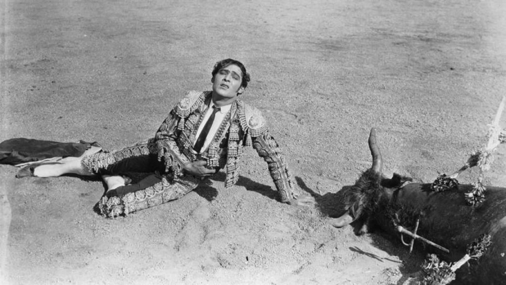 A wounded Juan next to a bull