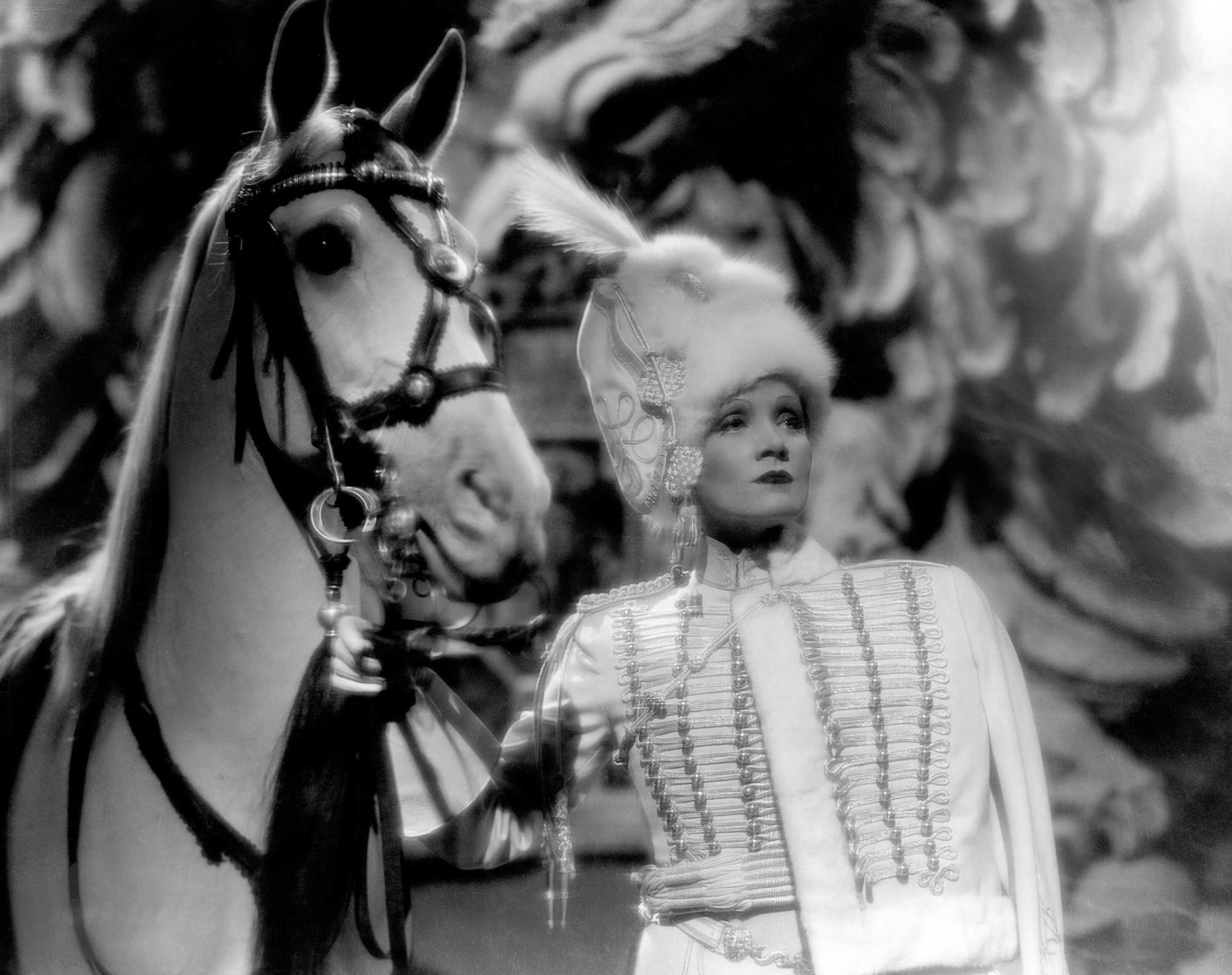 Marlene Dietrich in fur hat and with horse