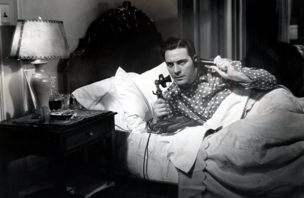 Sam Spade in bed on the phone