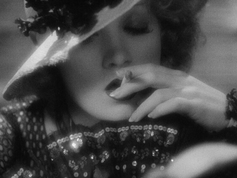 An exquisitely lit Marlene Dietrich draws on a cigarette