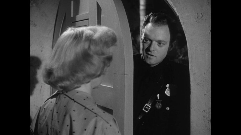 Mrs Gilvray opens the door to cop Webb Garwood