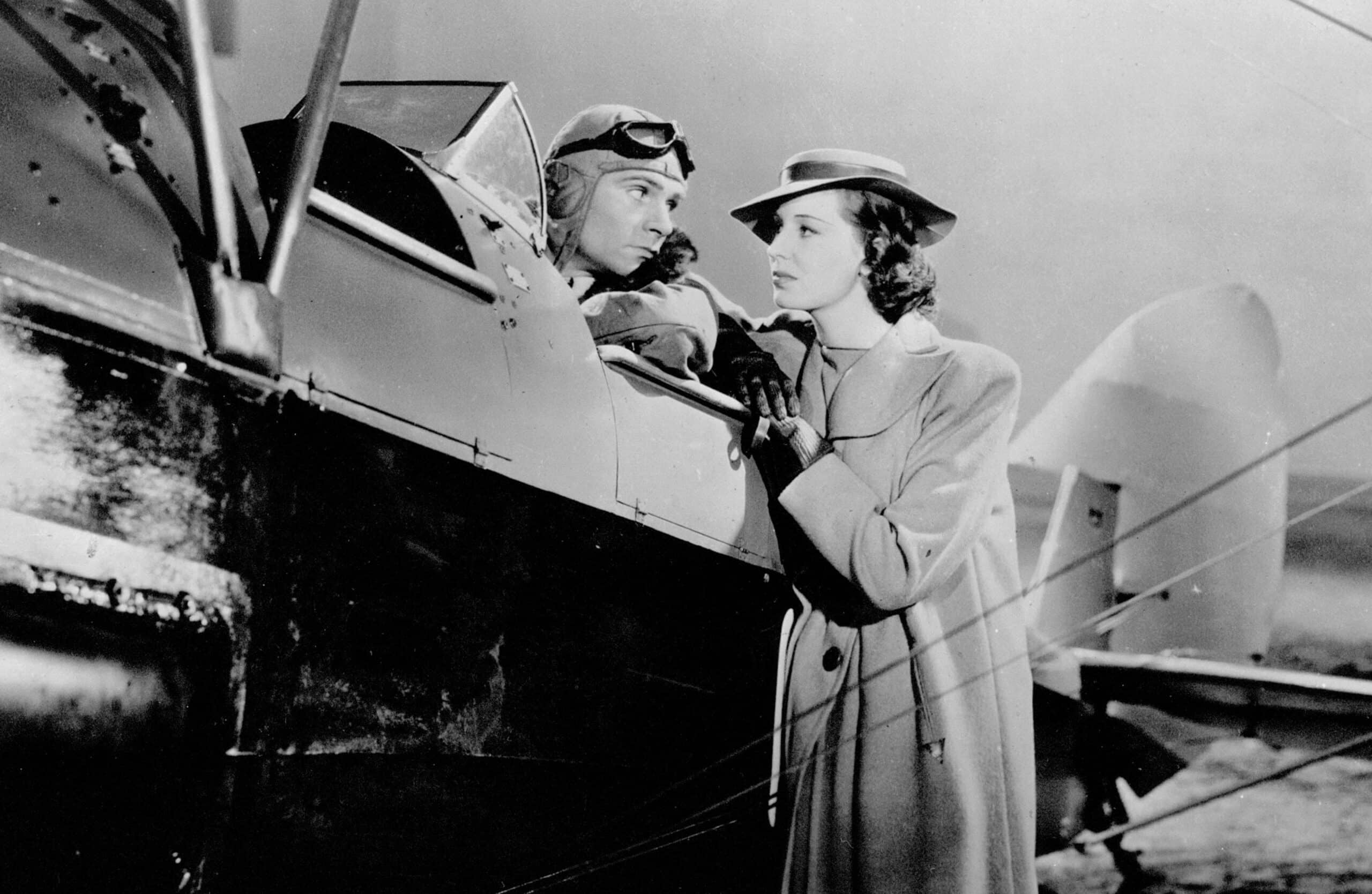 Pilot Tony McVane in a plane talking to journalist Kay Hammond
