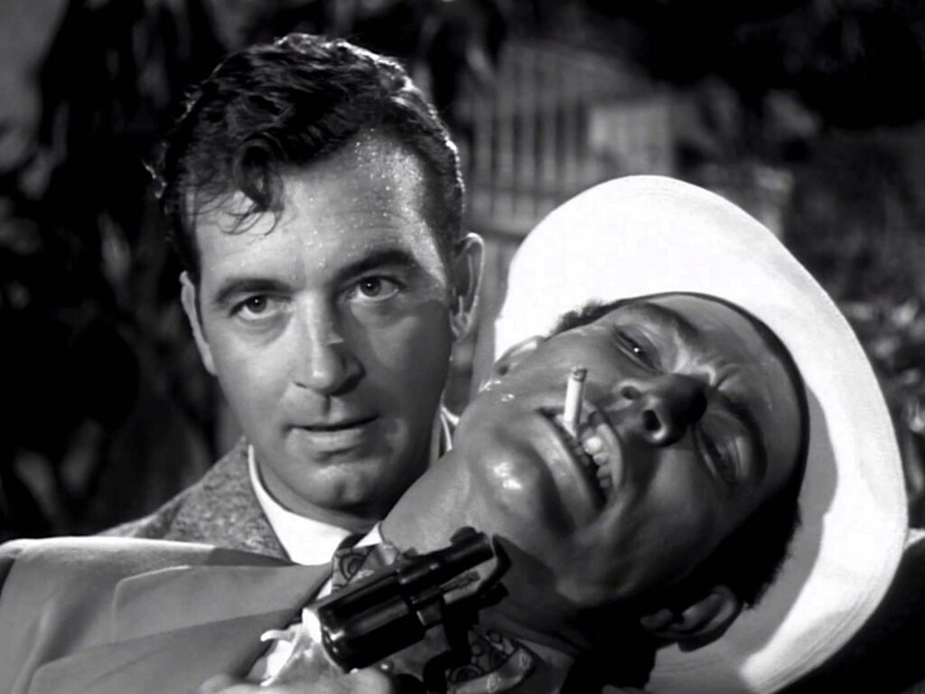 Joe holds a gun to the head of Tony (Lee Van Cleef)