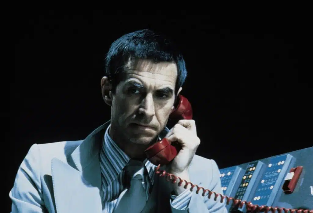 Anthony Perkins as the tech mastermind monitoring everything