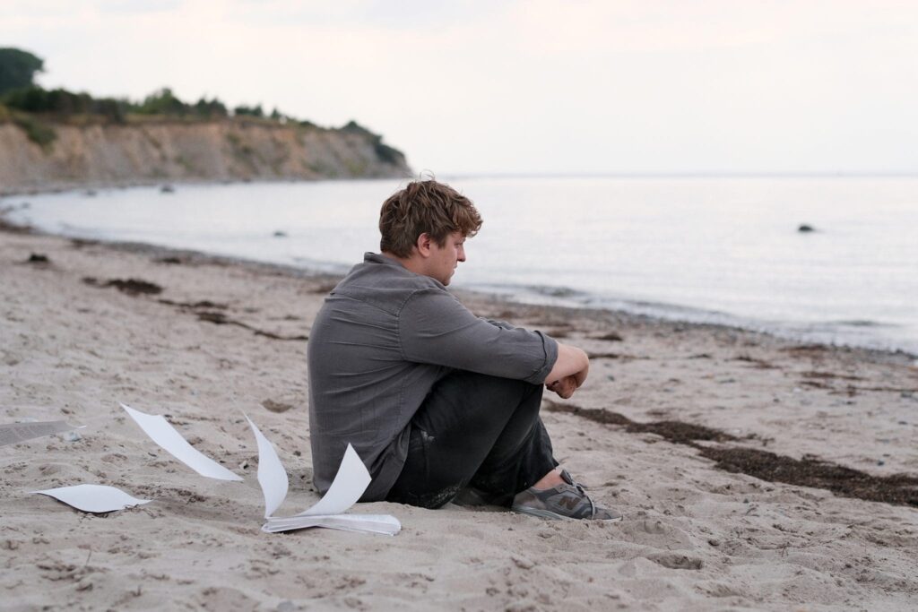 Leon lets the pages of his novel scatter in the wind