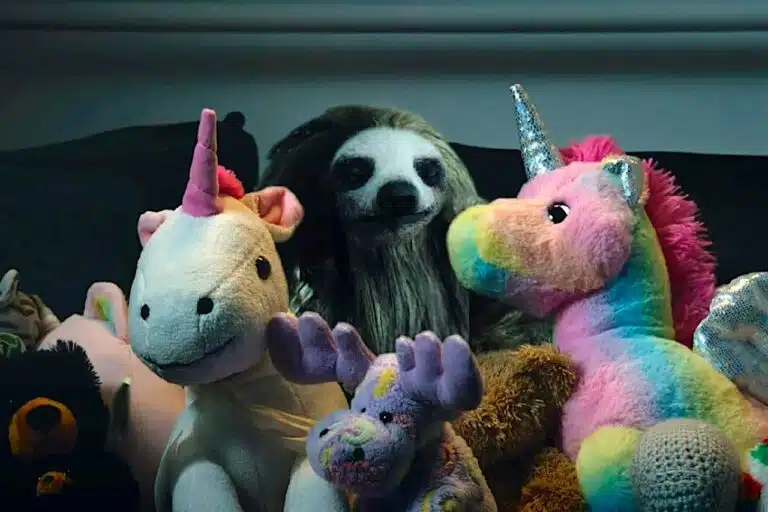 The sloth hides among the toys