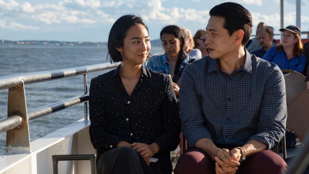 Nora and Hae Sung on the deck of a tourist boat