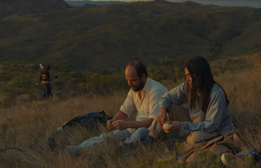 Morán and Norma sit quietly on a hillside