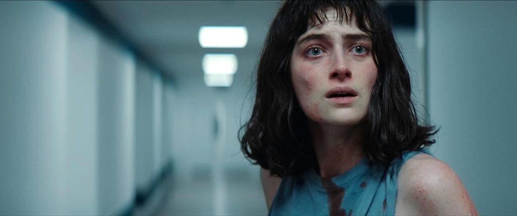 Claire looking frightened in a corridor