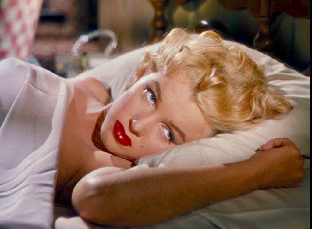Rose in bed, red lips prominent