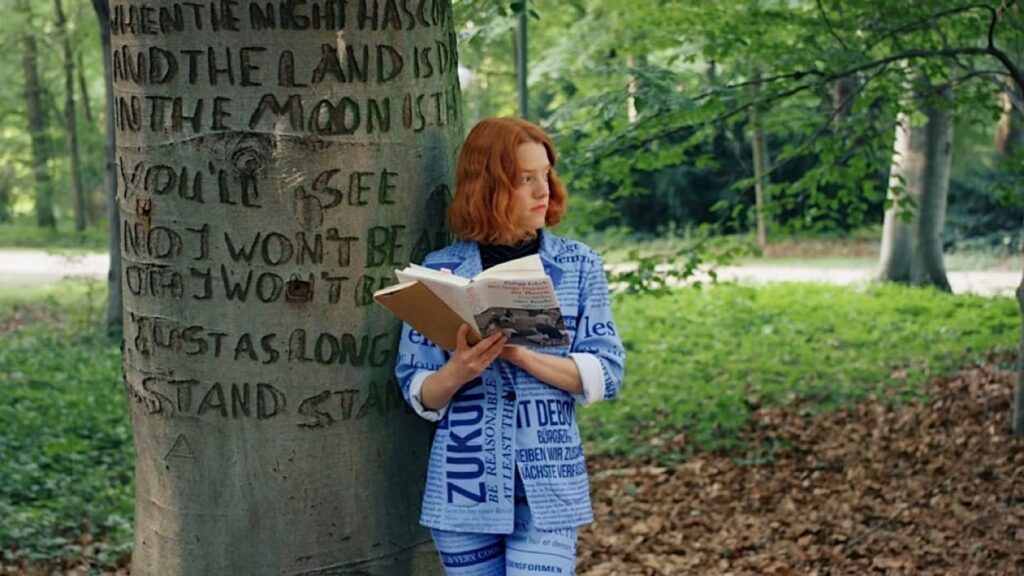 Nola in her blue, newspaper-headline suit