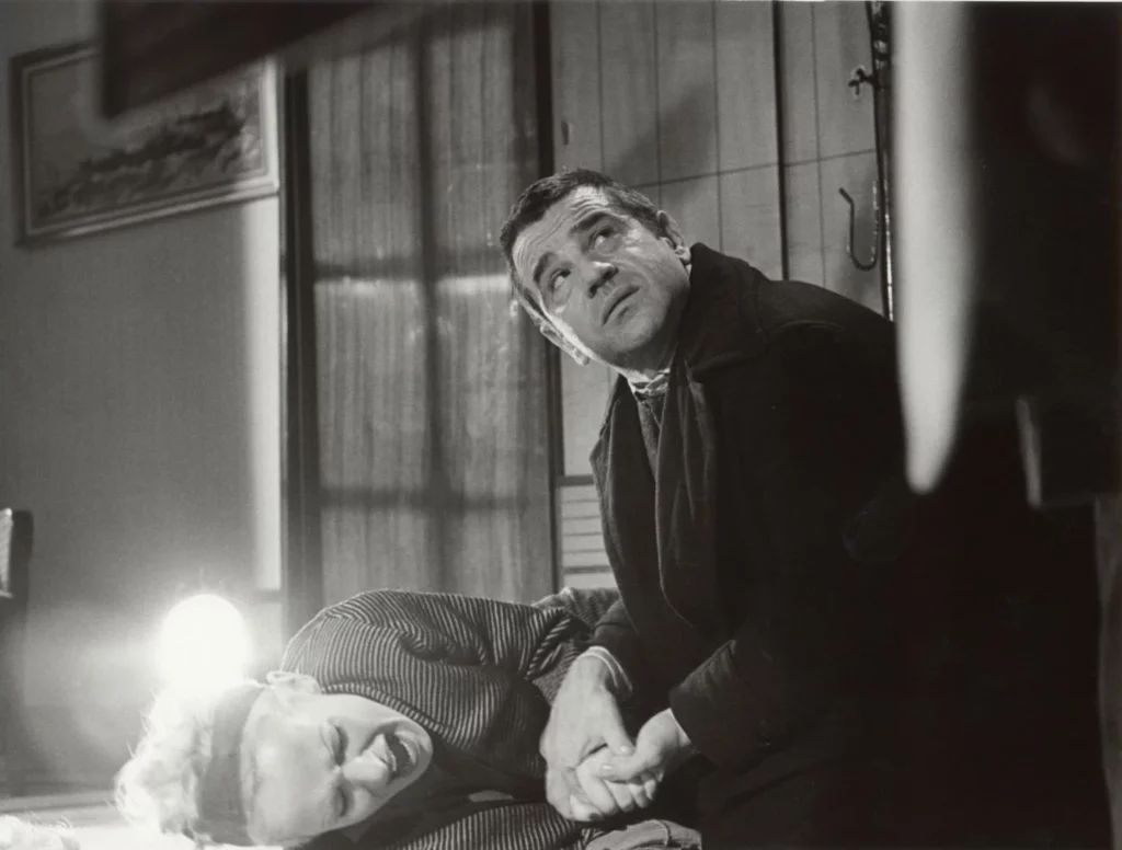 Veronika screams on the floor while Robert comforts her