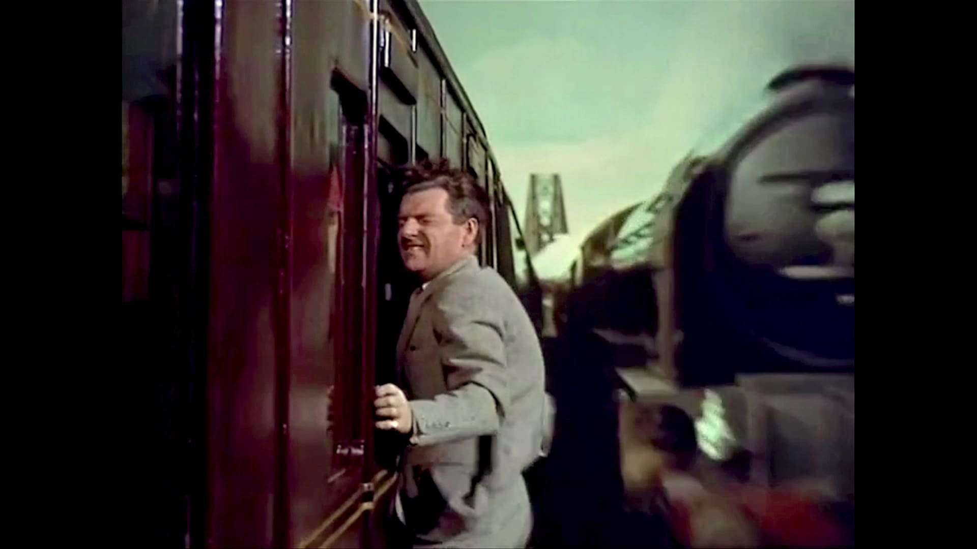 Richard Hannay clambering along the outside of a train