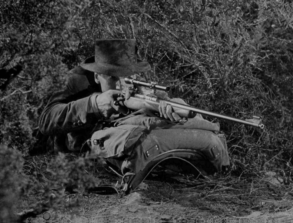 Captain Thorndike takes aim with is rifle