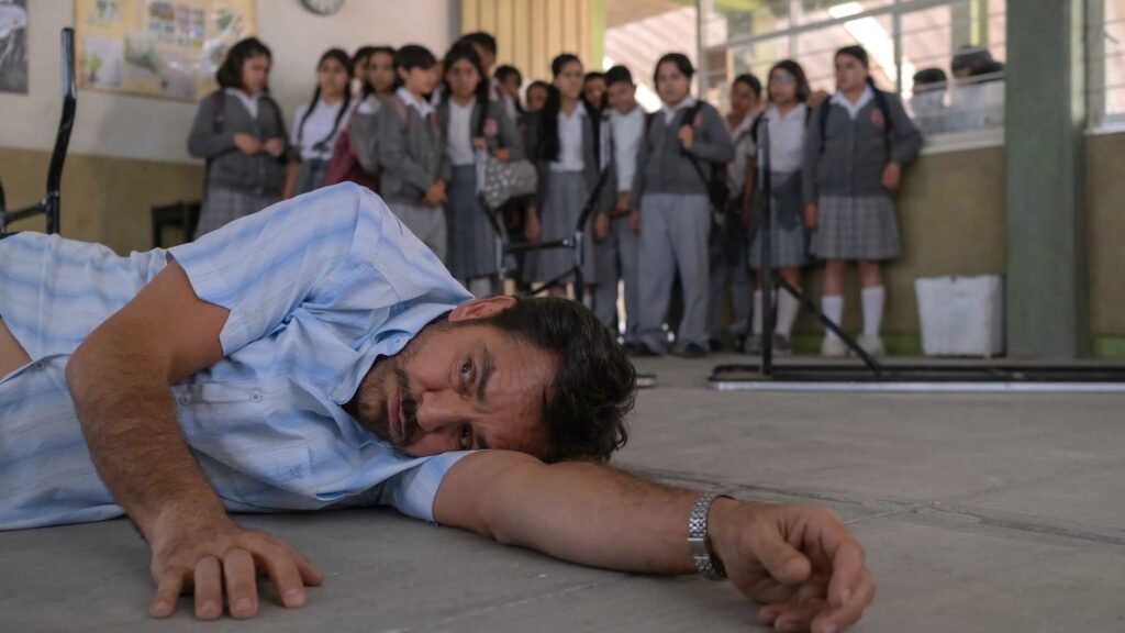 Sergio gets the class's attention by lying on the ground