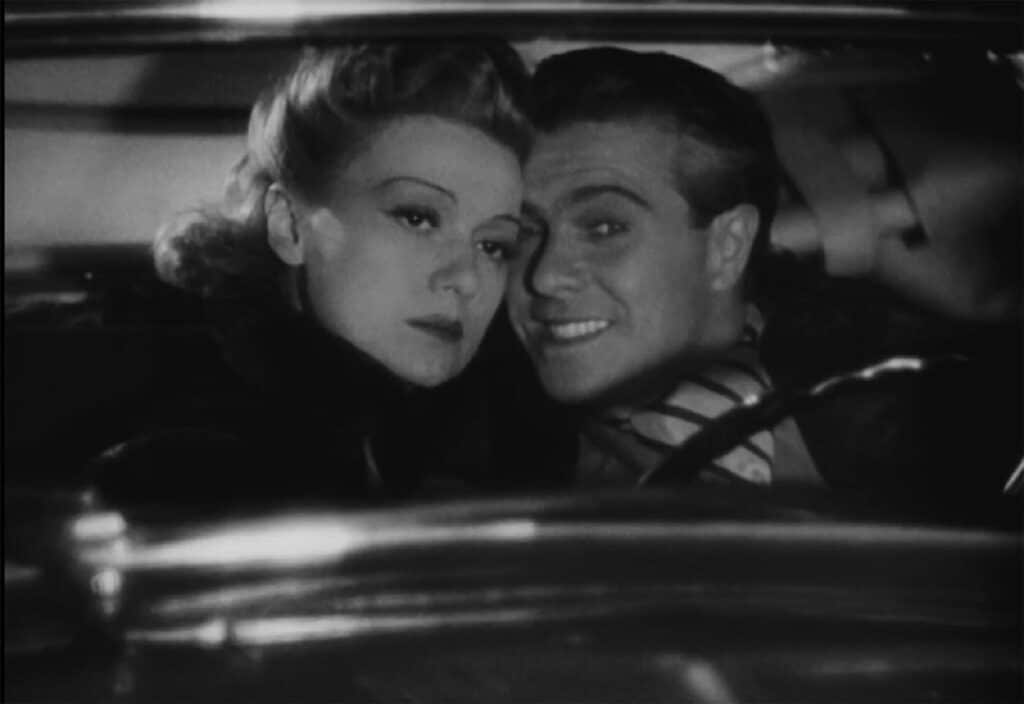 Unhappy Evelyn and happy Georges in a car
