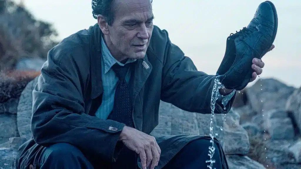 Julio pours water from his shoe