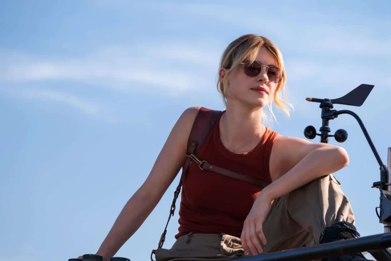 Kate in shades sits on the roof of a chaser truck