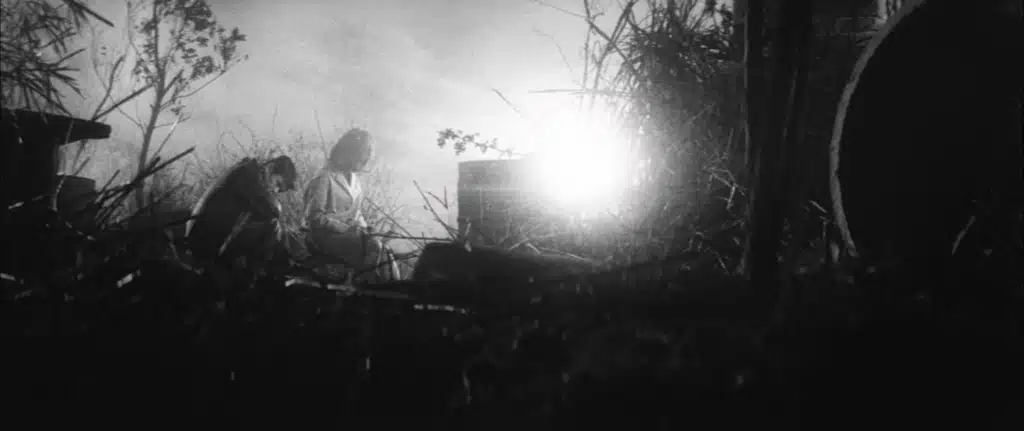 A man and a woman by a graveside