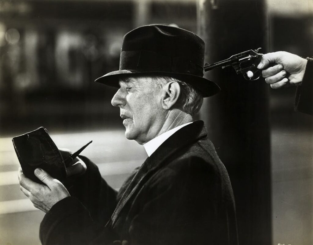 Father Lambert with a gun to his head