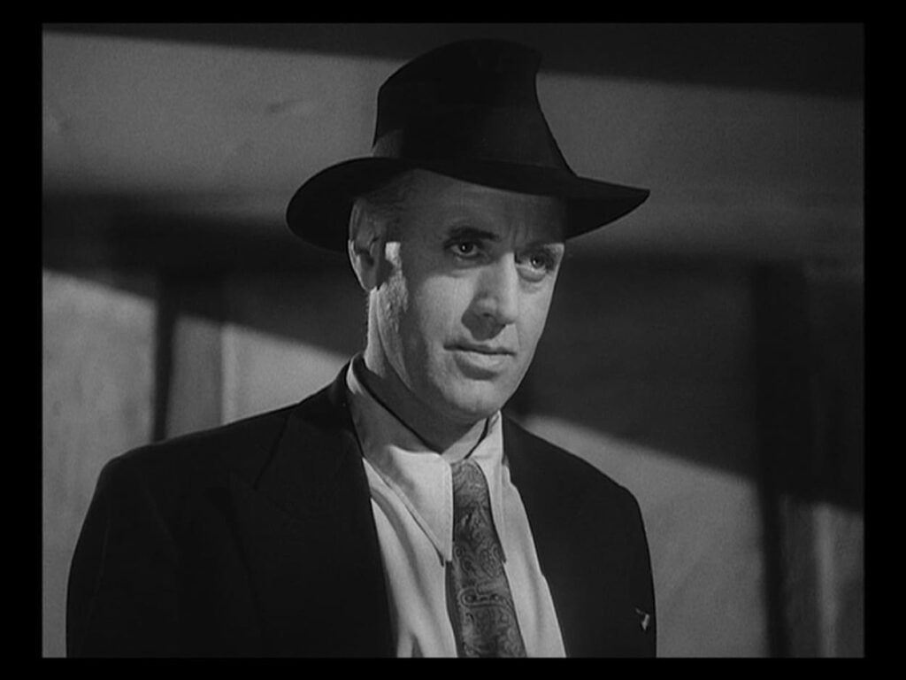 Inspector Cockrill in black hat