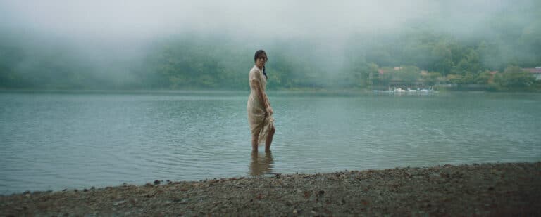 Akiko standing in shallow water in a lake